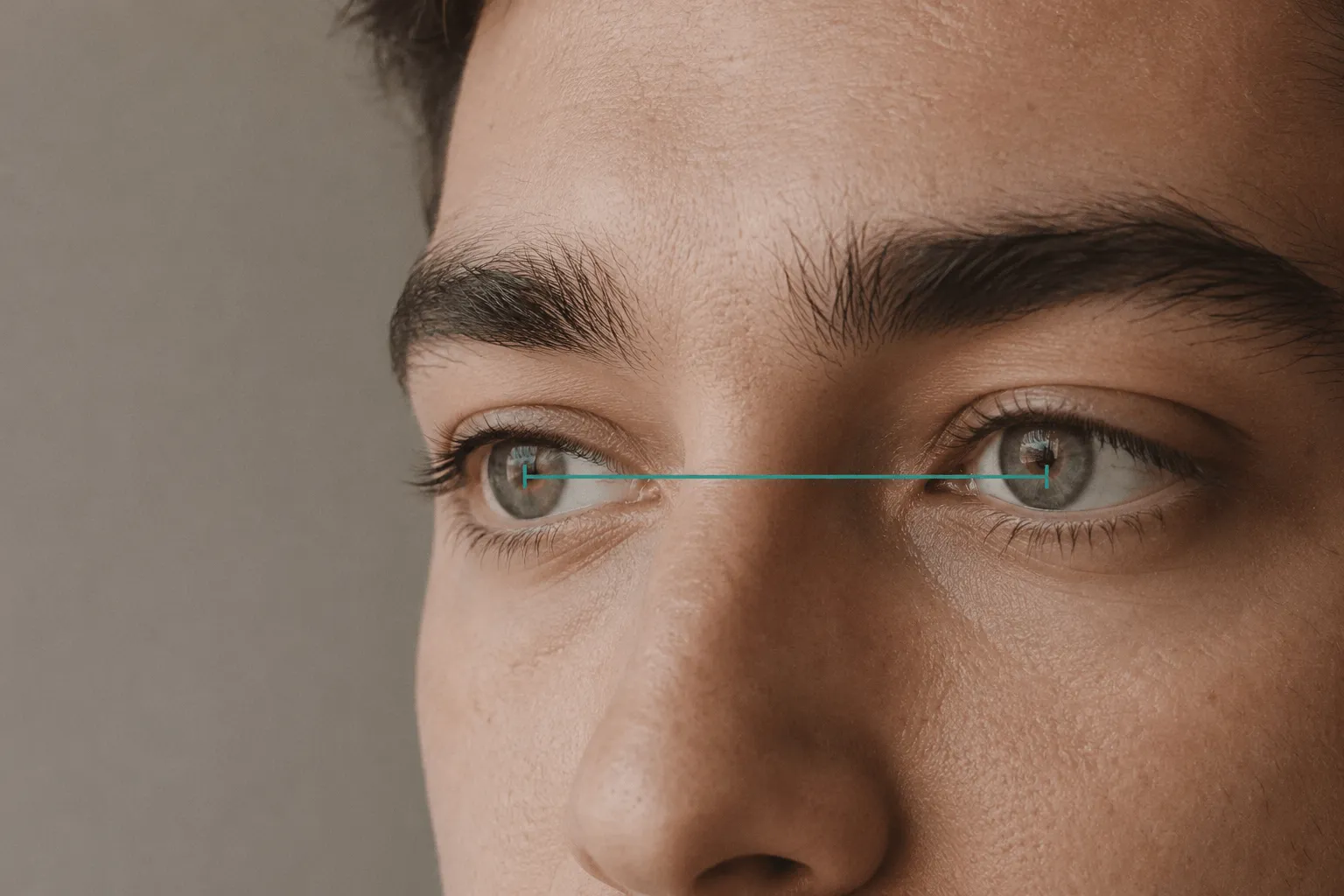 Diagram of pupillary distance: a measured line spanning pupil centre to pupil centre on a close-up of adult eyes